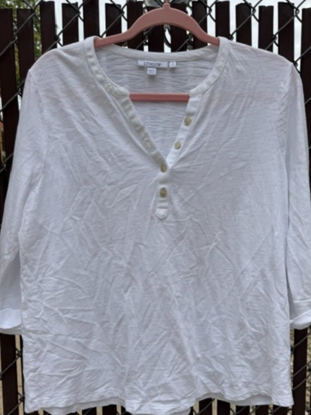 white Chico's brand V-neck henley top with short roll-tab sleeves with buckles